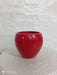 Apple-shaped ceramic plant pot in vibrant red