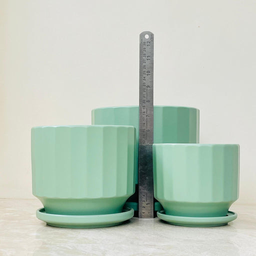 Medium ribbed turquoise ceramic planter with matching saucer