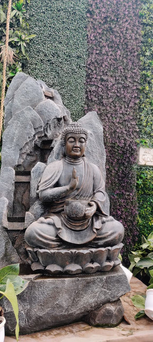 Buddha garden statue with rock backdrop for outdoor Zen decor