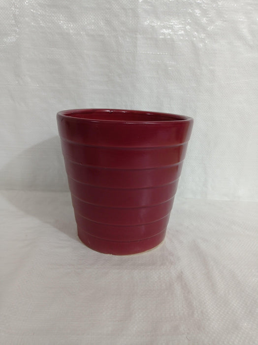 Stylish round ceramic planter in grape wine color