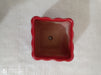 Elegant small red ceramic pot with a glossy finish