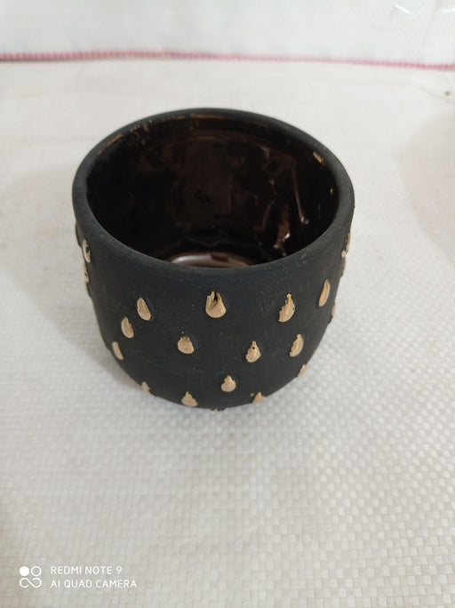 Stylish ceramic pot with sleek black gold design