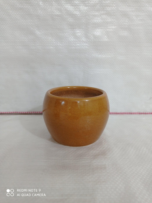 Handi-shaped round ceramic pot in yellowish brown color