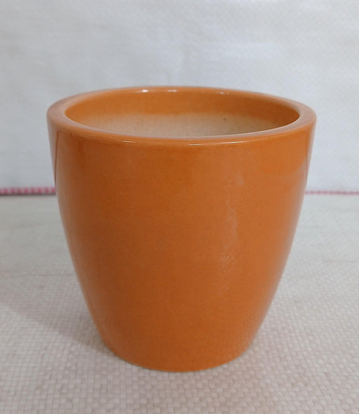 Modern ceramic planter in light orange color