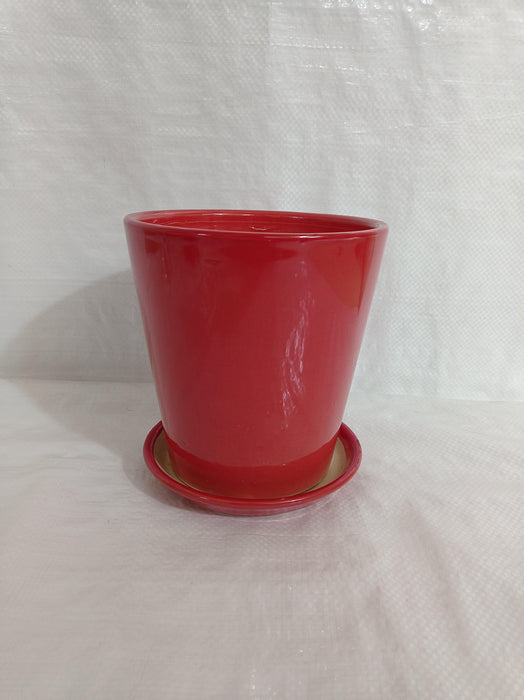 Small red ceramic pot with drainage hole